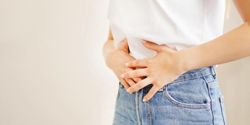 Stock image of woman with digestive issues. | Credit: Adobe Stock