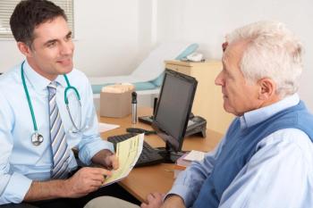 Doctor having a conversation with an older patient.