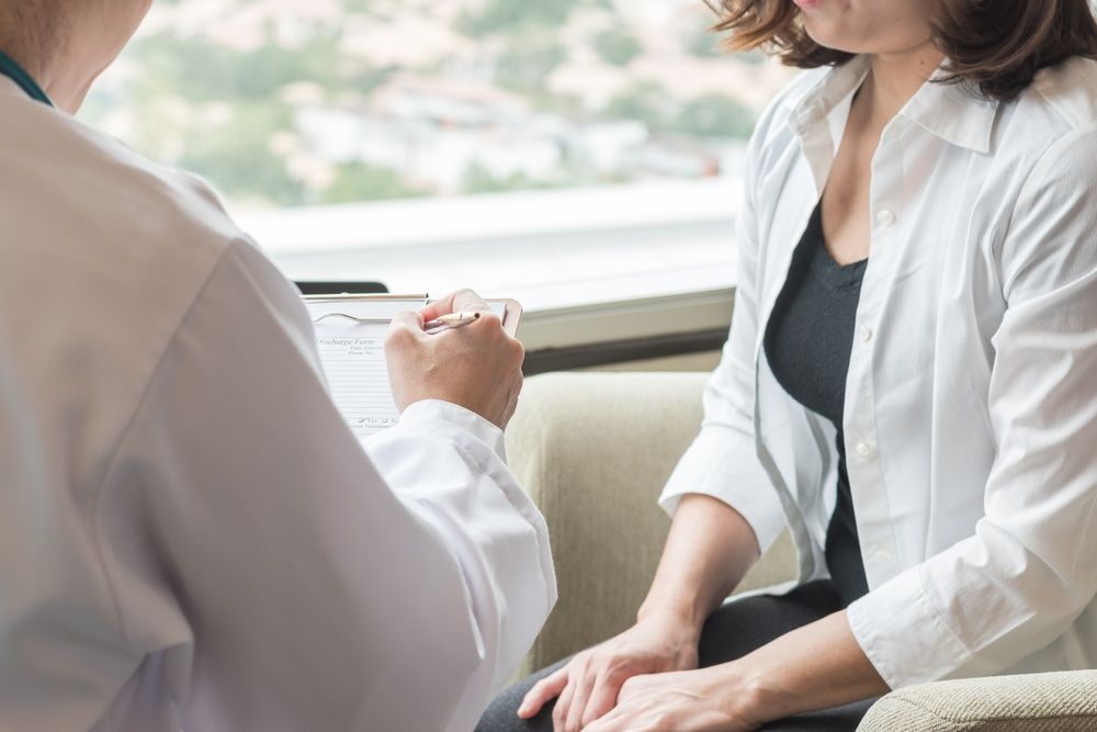 Woman and her doctor talking.
