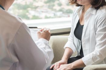Woman and her doctor talking.