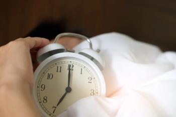 Close-up image of a man turning off his alarm clock. | Credit: Pexels (Acharaporn Kamornboonyarush)