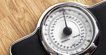 Close-up of the numbers on a bathroom scale.