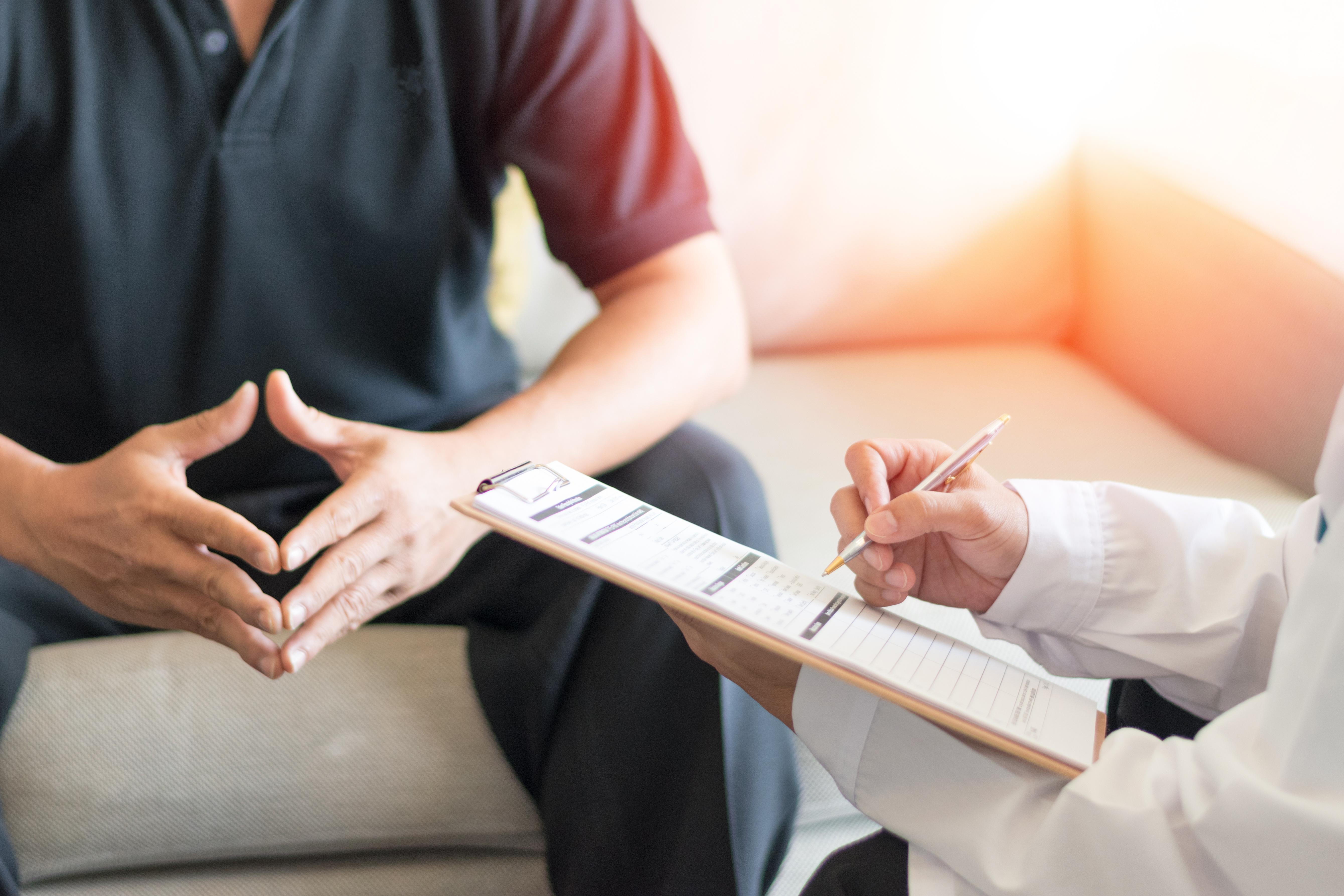 Doctor and patient having a discussion during an office visit.