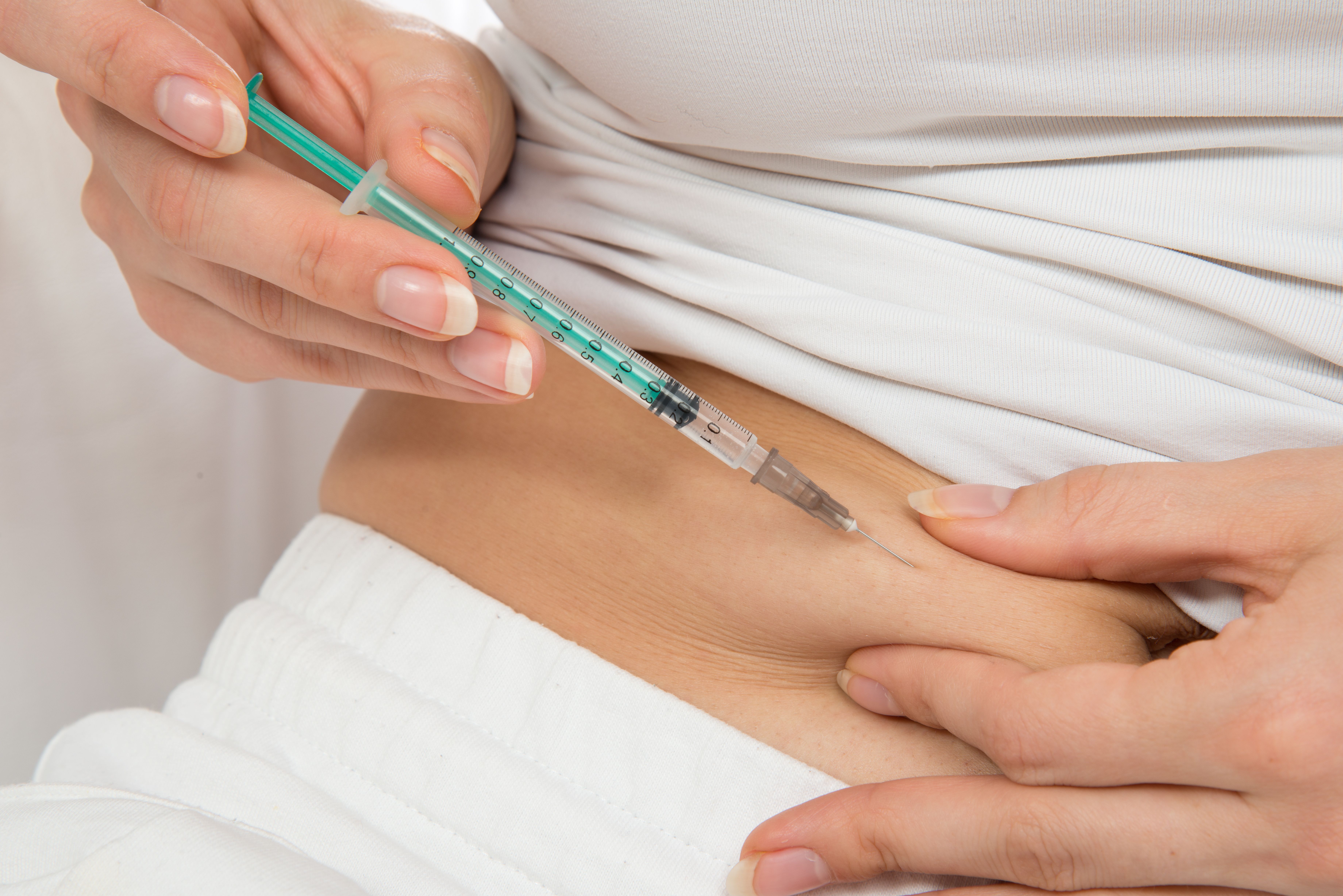 A patient giving themselves an insulin injection.