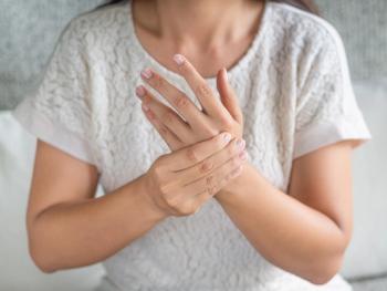 Woman experiencing hand pain.