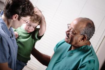 A pediatrician taking care of a child. 