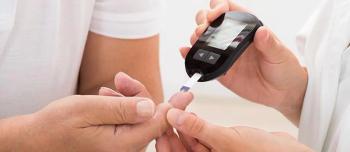 Person helping somebody with diabetes check their blood sugar.