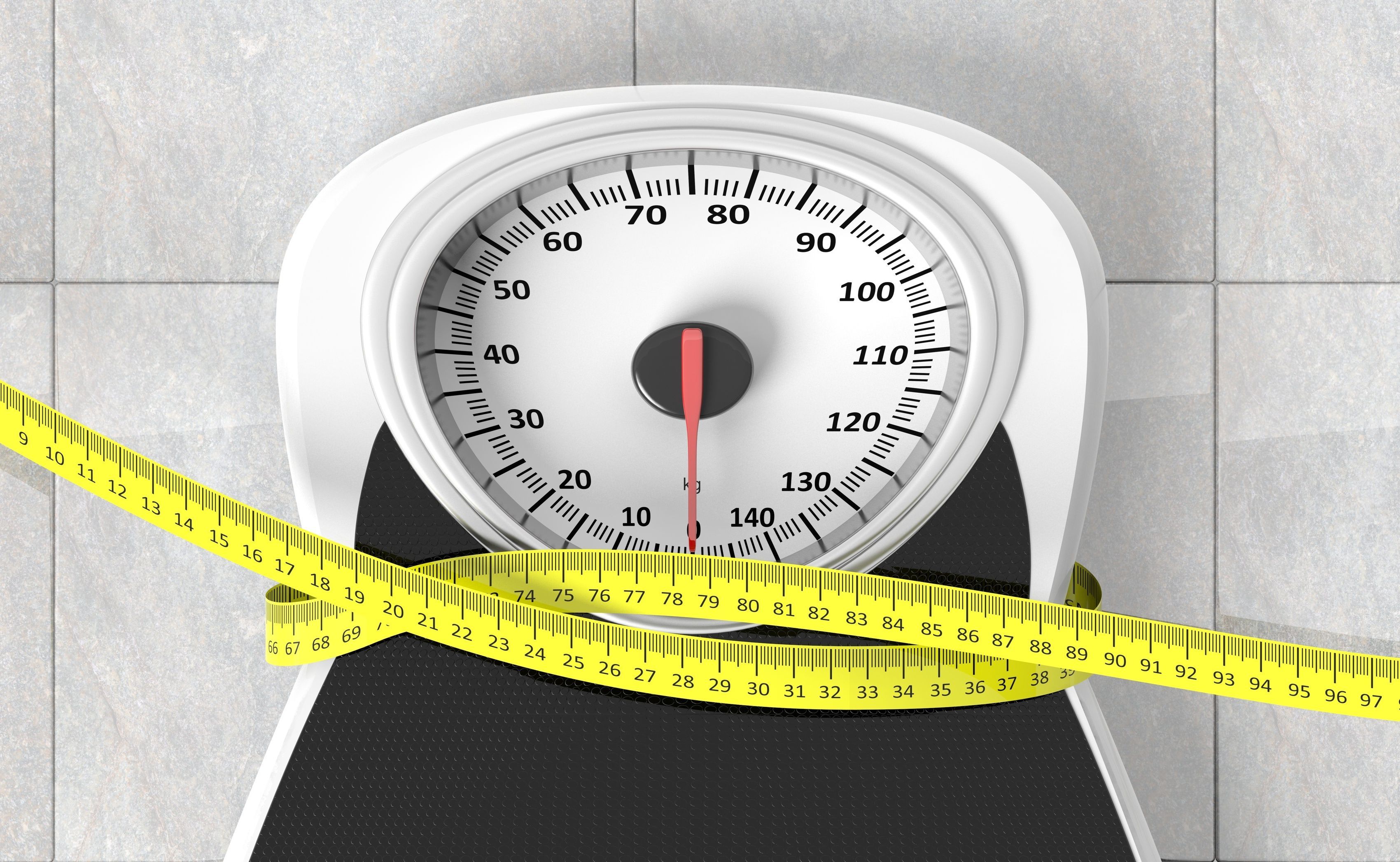 Measuring tape wrapped around a scale
