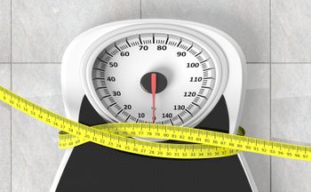 Measuring tape wrapped around a scale
