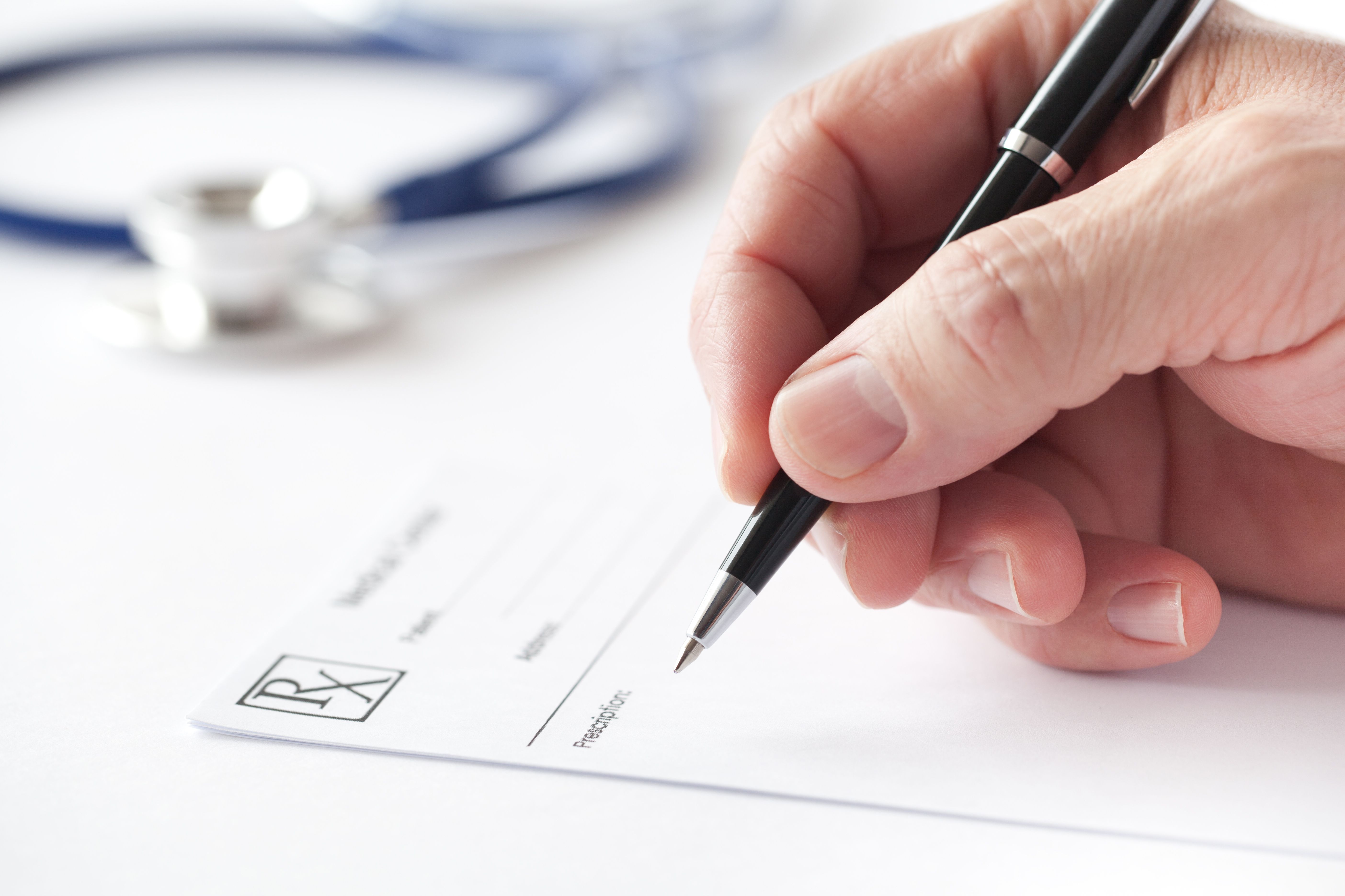 Stock art of a health care provider writing a prescription
