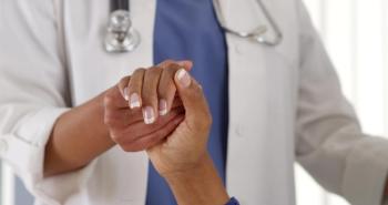 Doctor and patient holding hands.