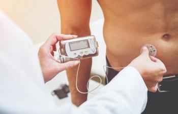 A patient holding their insulin pump.