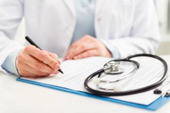 Cardiologist writing a prescription for a patient.