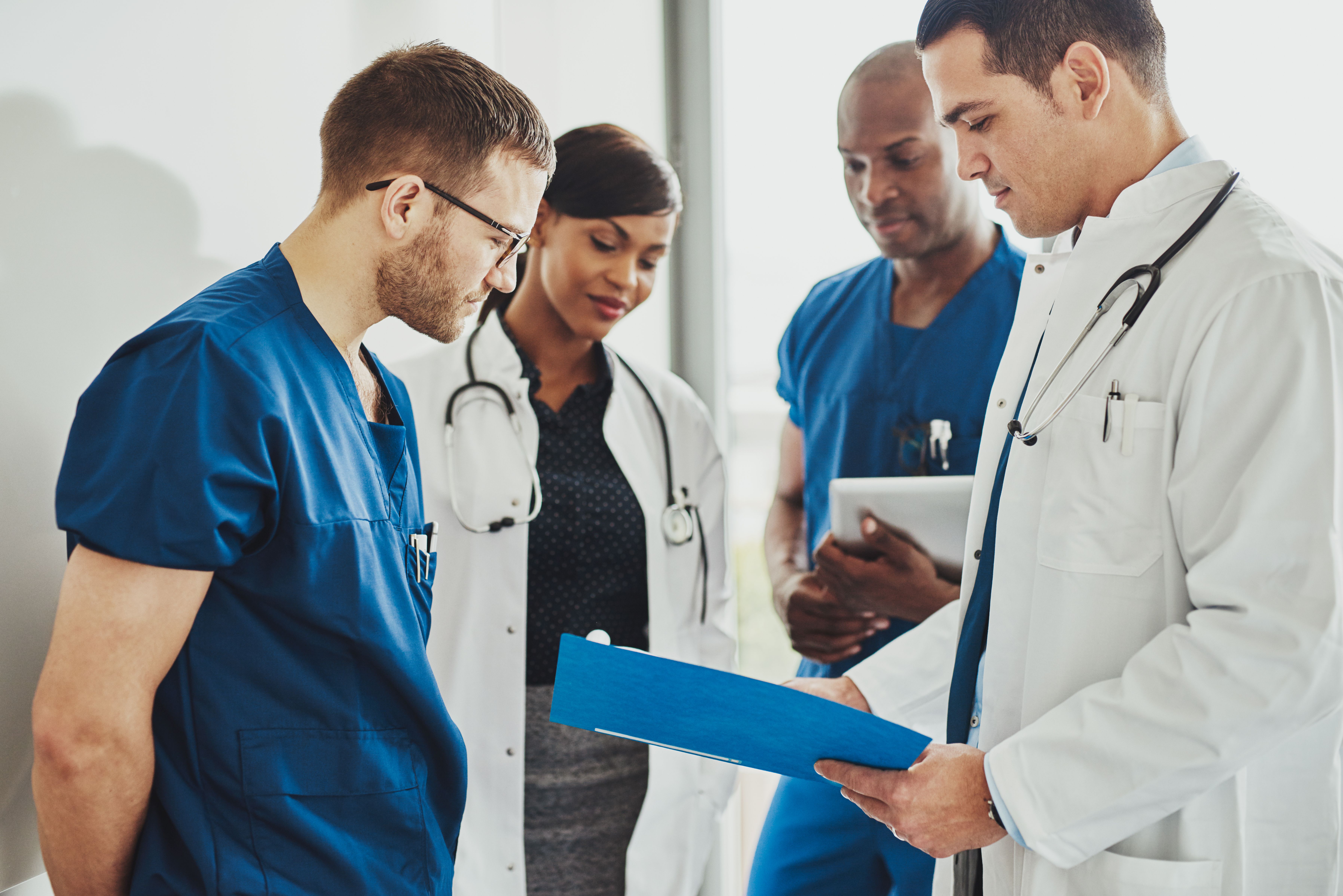 Doctors discussing news and guideline updates. | Credit: Adobe Stock