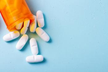 Statins spilling out of a prescription pill bottle.