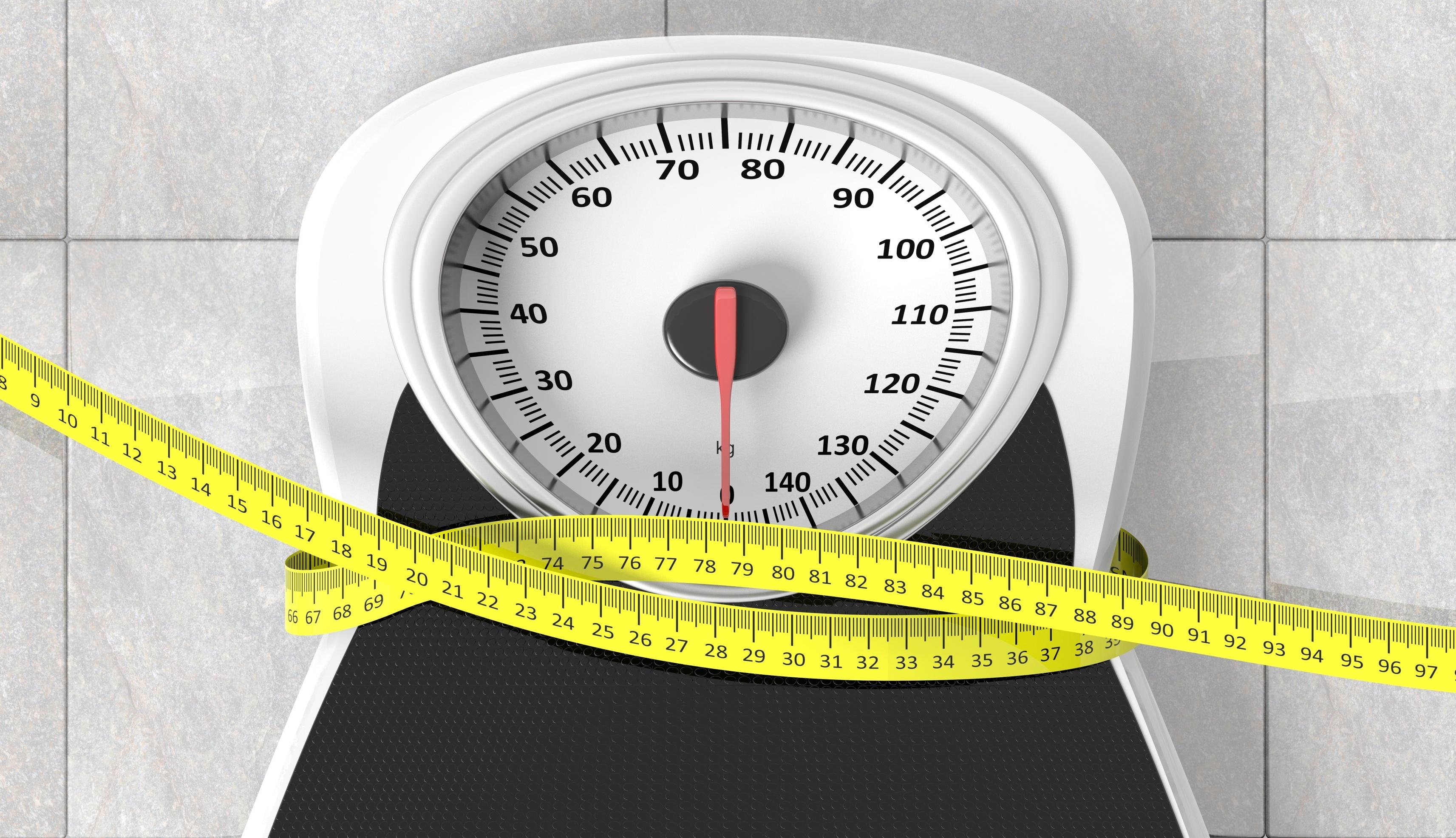 Scale enveloped with a measuring tape.