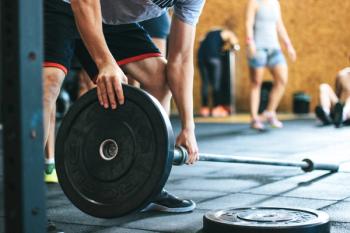 Person engaging in weight training at the gym