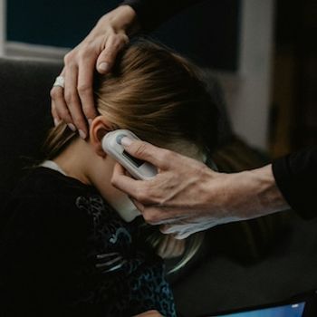 Checking a child's temperature | Image Credit: Kelly Sikkema/Unsplash
