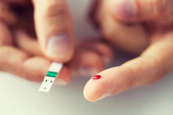 Patient with diabetes checking their blood glucose using a test strip.