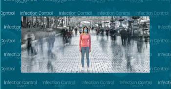 The young woman with a medical mask on her face stands on the crowded street. (Adobe Stock 329119752 by realstock1)