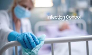 An EVS worker wiping down a handrail o  (Adobe Stock 1612822382 by evgenia_lo)