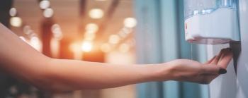 lady's arm reaching for hand sanitizer