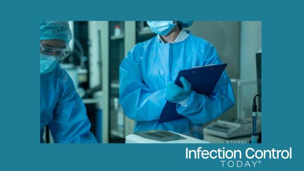 Medical workers in protective gear reviewing notes in a hospital laboratory, showing teamwork, safety, and careful record keeping. (Adobe Stock 2160794513 By NanSan)