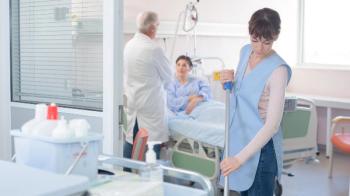 Employee mopping patient room