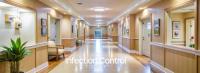 Well-lit and neat corridor in a nursing home setting  1019519801 by Udomner