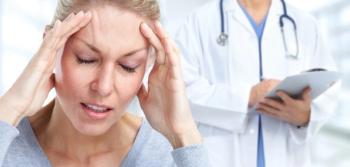 female patient holding her head