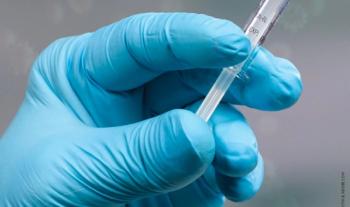 gloved hand holding a needle for the flu vaccination