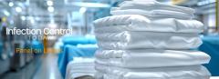 Stacked Clean White Sheets and Surgical Clothes in an Industrial Laundry Setting.  (Adobe Stock 834864411 by Anastasiia)