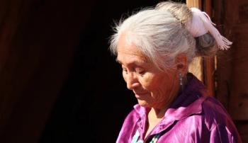 A Navajo Woman Looking Down Outdoors in Bright Sun  (Adobe Stock 18061809 by Katrina Brown)