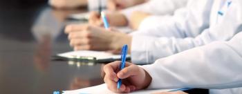 Medical professionals writing notes. (Adobe Stock, 79521560 by Africa Studio)