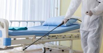 environmental person disinfecting hospital room 