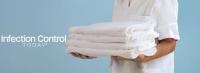 A health care professional presents a stack of pristine white textiles. (Adobe Stock 1506900633 Travel Studio Stock)