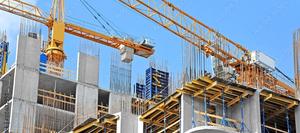 Crane and building construction site against blue sky ©Unkas Photo stock.adobe.com