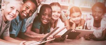 Kids smiling, holding books.