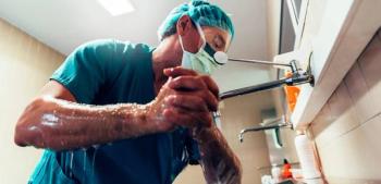 Physician washing his hands and arms 
