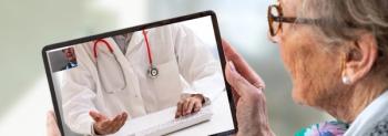 elderly woman holding tablet for telehealth visit
