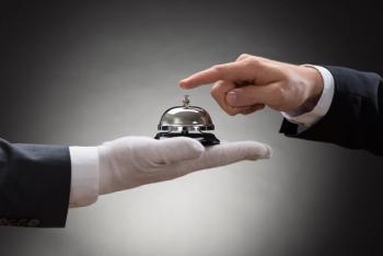 white glove holding bell concierge concept