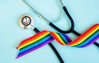 LGBTQ flag and stethoscope