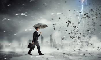 business man walking through a storm with an umbrella