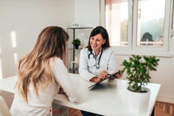 woman physician talking to another woman
