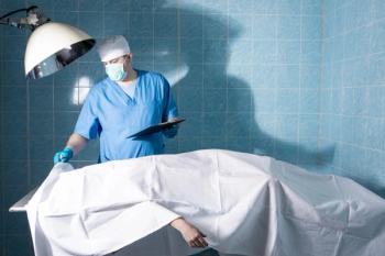 Doctor uncovering corpse ©Demian-stock.adobe.com