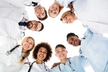 physicians doctors form happy huddle: © Andrey Popov - stock.adobe.com