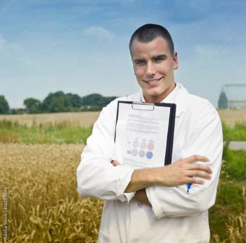 doctor holding medical chart with farm in background ©Noam-stock.adobe.com