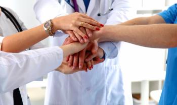medical team stacking hands: © lenetsnikolai - stock.adobe.com