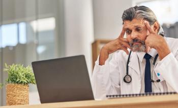 discouraged doctor staring at laptop computer ©Bettencourt/peopleimages.com-stock.adobe.com