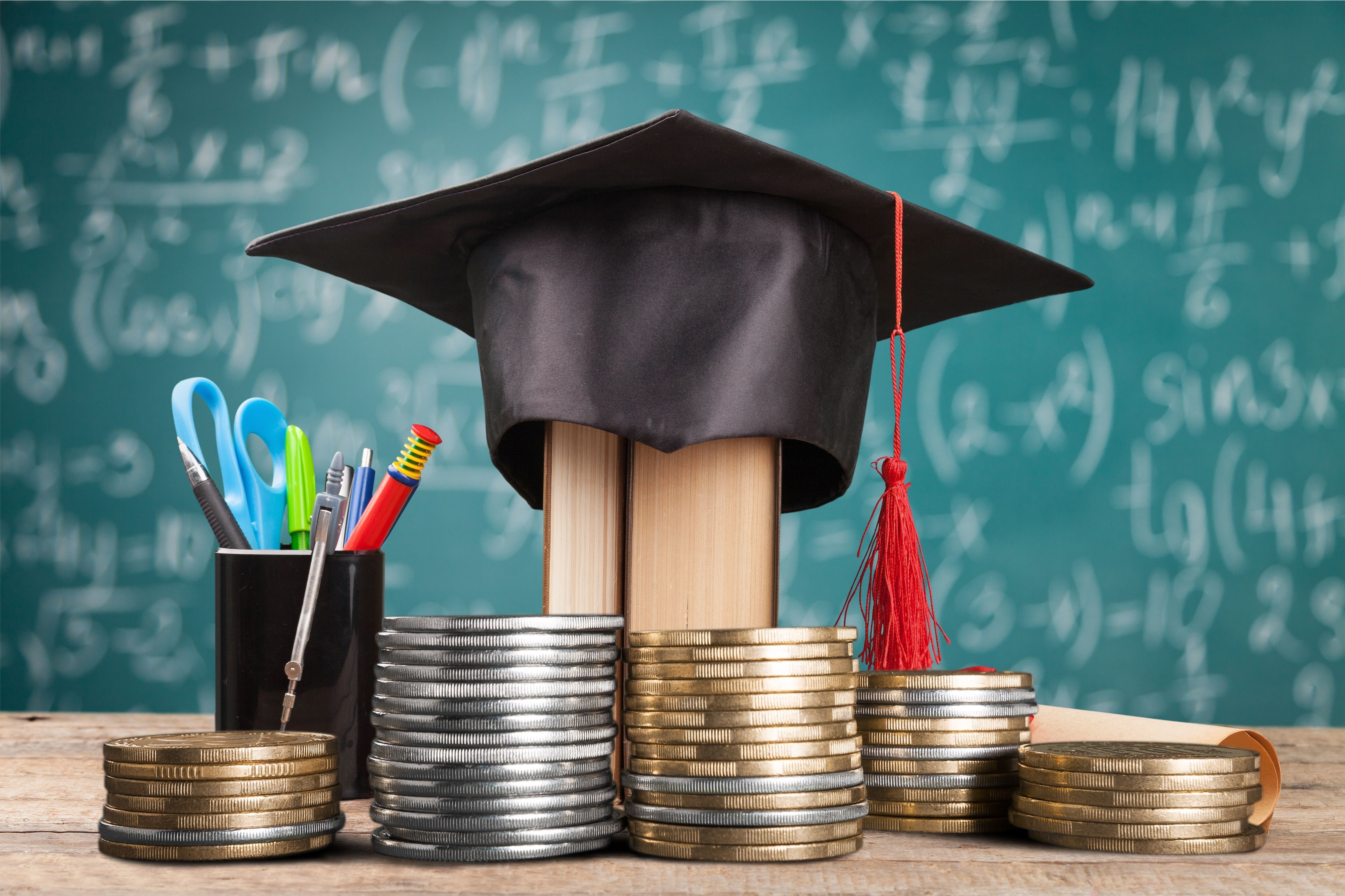 book wearing graduation cap student loan concept